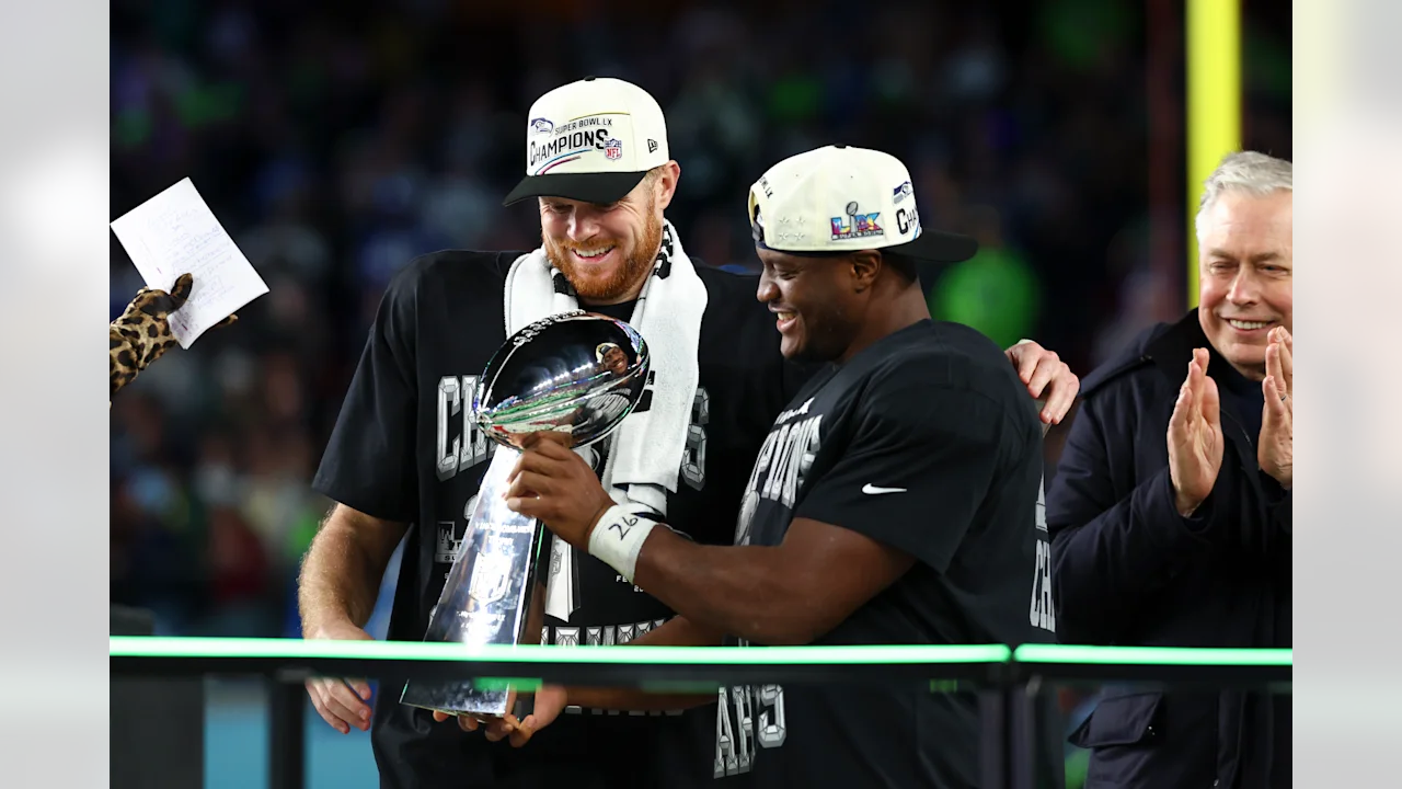 Players holding Lombardi Trophy